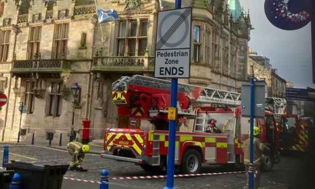 Firefighters secure the clock in Dunfermline