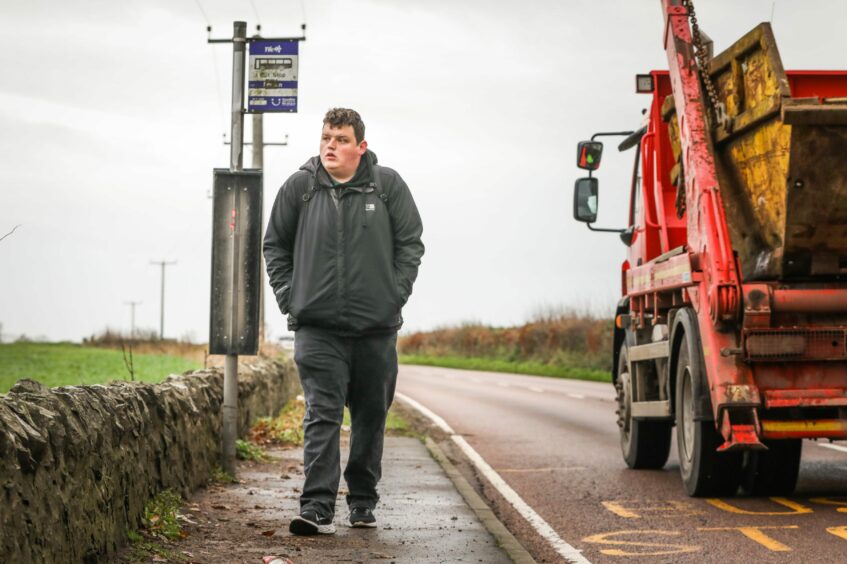 The X54 bus service from Newport-on-Tay was cut and now bus users must cross a busy dual carriageway to reach the bus stop. Chris Cameron is pictured here on a short stretch of pavement on the road. 