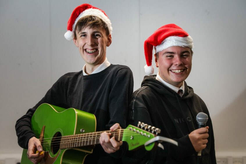 Ewan Ferrie, 14, with guitar and Cole Conner, 15, of Braeview Academy.