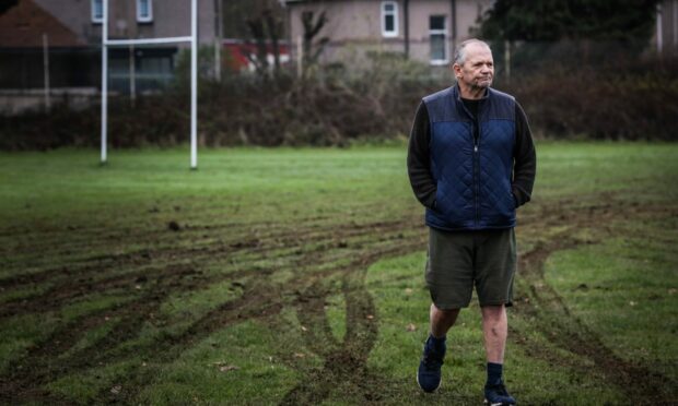 Dundee Rugby Club convenor Dougie Clark by the damage to the pitch. Image: Mhairi Edwards/DCThomson
