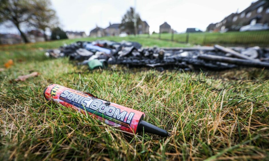 Fireworks and charred rubbish on the grass in the aftermath of the Kirkton riots.
