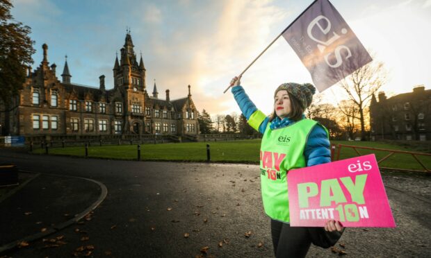 A teacher on the picket line during EIS strikes in November last year.