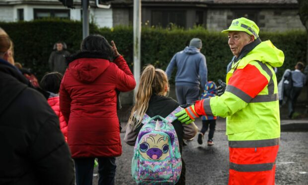 Lollipop man Sandy Bullions without his lollipop on Ancrum Road on Friday. Image: Mhairi Edwards/DCThomson