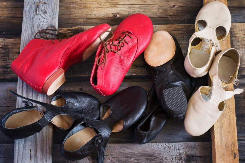 photo shows a pile of children's dance shoes.