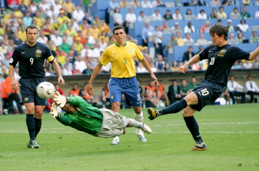Harry Kewell, right, shoots against Brazil in the 2006 World Cup as Mark Viduka, left, watches on.
