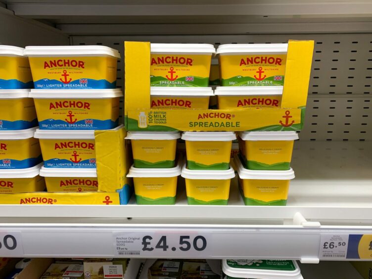 photo shows tubs of butter on a supermarket shelf above a sign saying £4.50