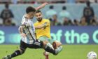 Lisandro Martnez puts in a contender for tackle of the tournament to stop wonder goal from Dundee United star Aziz Behich. Image: Shutterstock