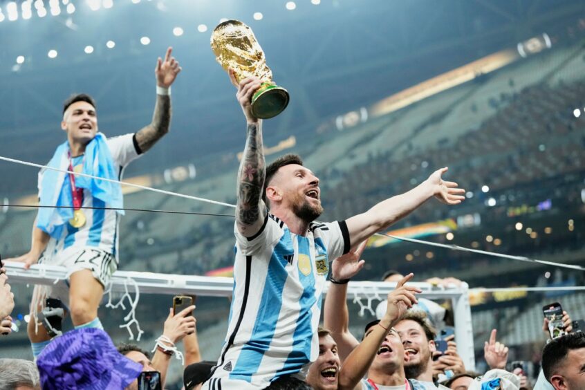 Lionel Messi lifts the World Cup for Argentina.