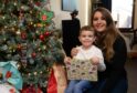 Stacey Allan and her four-year-old son, Zac Young, who has been exchanging gifts with binmen in Montrose. Image: Paul Reid.