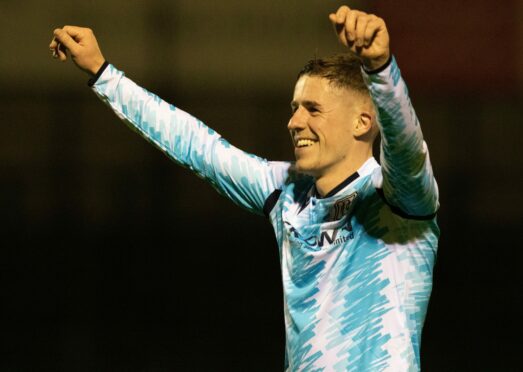 Luke McCowan salutes the Dundee fans at Somerset Park. Image: SNS.