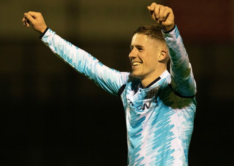 Luke McCowan salutes the Dundee fans after victory at Somerset Park