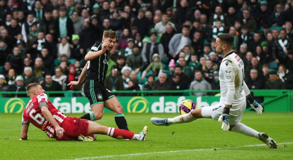 Celtic's James Forrest has a shot saved by Remi Matthews. 