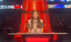 Aimee sitting in one of the coach's chairs on The Voice Kids. Image: Lee McKelvie