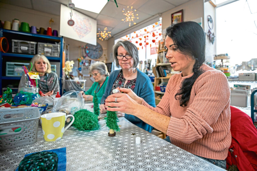 people making eco-friendly christmas decorations at nest