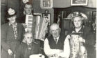 Mary Brooksbank with nephew Fred Soutar (with accordion), parents Rosie and Sandy Soutar (seated) and their friend Mrs Hughes (standing), at her parents' diamond wedding anniversary in 1948.