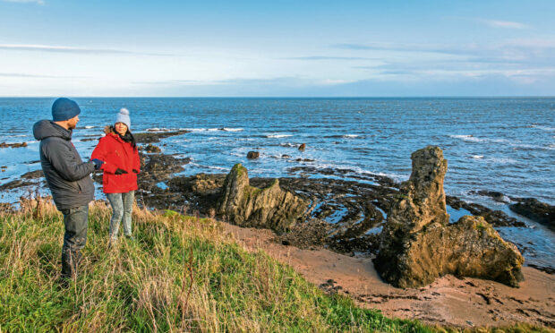 Rory Fyfe and Gayle Ritchie check out the Rock and Spindle formation near St Andrews. Picture: Steve Brown.