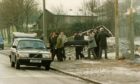Police remove the body parts of Gordon Dunbar from Dundee Law following the grim discovery on December 30 1992. Image: DC Thomson.