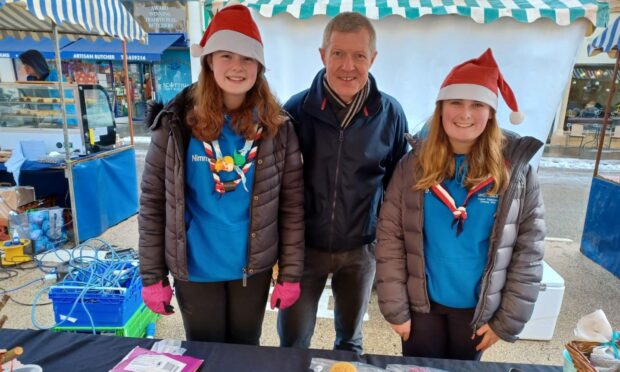 Cupar Explorer Scouts Zoe Nimmo (left) and Beth Harvie with North East Fife MSP Willie Rennie who visited their stall. Image: Michael Alexander