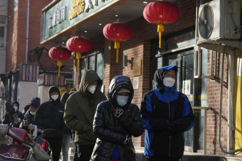 Residents line up outside a pharmacy to purchase medicine in preparation for a possible wave of Covid-19 outbreaks in Beijing