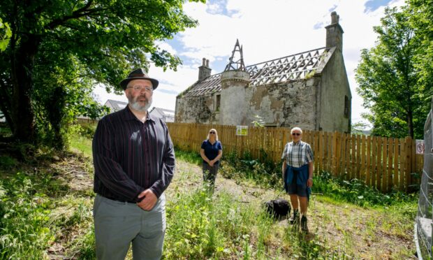 Councillor Jonny Tepp, front, with Wormit residents David Cowley and Wendy Irons.