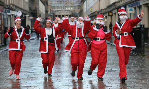 Santas dash down Reform Street. Image: Gareth Jennings/ DC Thomson.