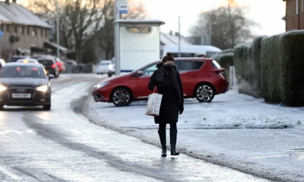 Residents forced to walk on the road due to icy pavements on Fintry Drive, Dundee, on Monday. Image: Gareth Jennings/DC Thomson.