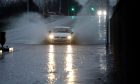 A car wades through flood waters in Dundee.