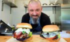 Orkun with two of his burgers.