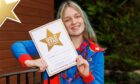 A Courier Gold Star has been awarded to Iona Smith in recognition of her volunteering at Rainbows. Image: Kenny Smith/DC Thomson.