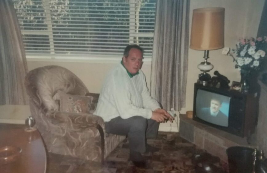 The writer's grandfather in his chair in front of the televison.