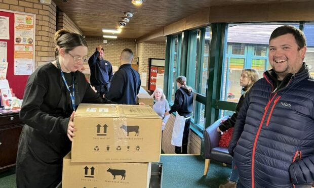 Staff member Andrew Jarron delivers some of the packs to a local larder.