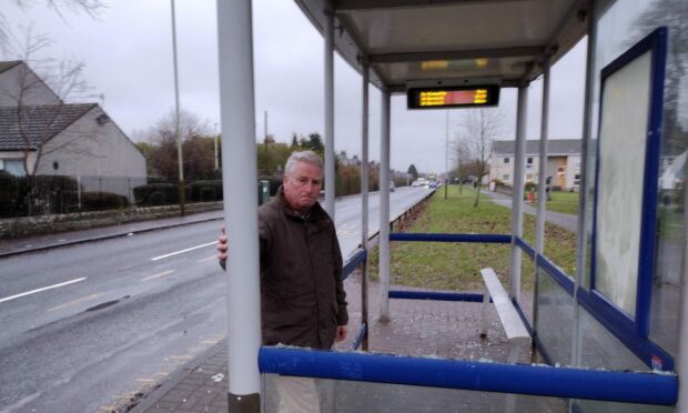 Councillor Craig Duncan with a vandalised bus shelter in his waqrd. Image: Craig Duncan