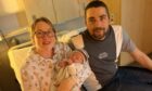 Tayside and Fife's first Christmas Day baby. Alexandru Junior Archie Bereczki with proud parents  
Elizabeth and Alex Bereczki. Image: NHS Fife.