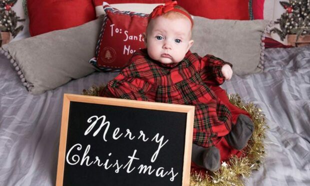 Eight-month-old Ivy Dickson, from Dundee, posed for a special festive portrait on her first Christmas. Image: reader supplied.
