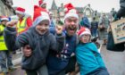 Leo Pooler, Ross and Finlay Dempster get ready for the Santa run at The Square, Aberfeldy. Image: Kim Cessford/DC Thomson.