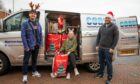 Kieran Laidlaw (left) and Kevin Shaw ready to go on road after loading up with gifts with Stacey Wallace, of Help for Kids. Image: Kim Cessford / DC Thomson.