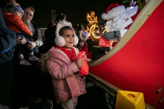 a child next to santas sleigh in dundee