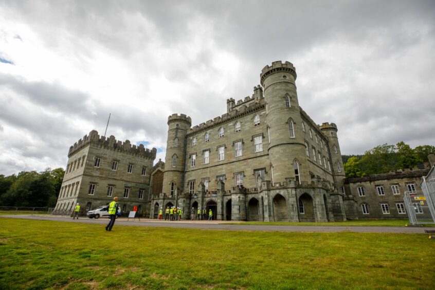 Taymouth Castle exterior with people in hard hats and hi-vis jackets outside
