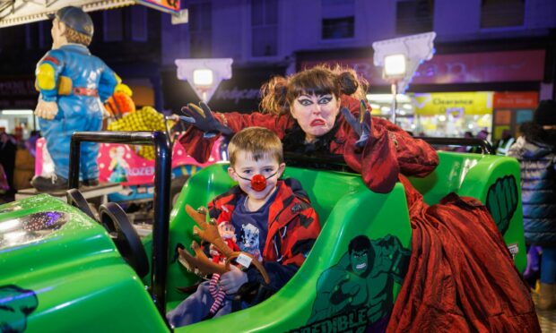 Kirsty Strachan as the wicked witch tries to scare 7 year old Jonas Gilfillan as he takes to the kiddie ride.