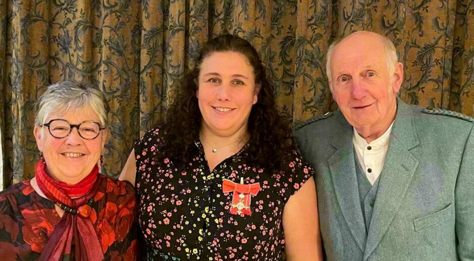 Colleen with parents Irene and Bill after receiving her MBE in 2021