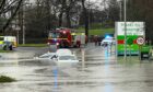 Emergency services attempting to rescue cars submerged in water at Halbeath Retail Park in Dunfermline. Image: Steven Brown.