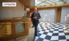John Swinney walking through the Scottish Parliament.