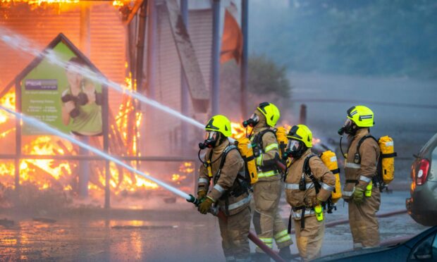 Firefighters battle the blaze, allegedly set by McKenzie-Robertson. Image: Steve MacDougall/DC Thomson.