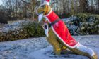 Rexie the Glenrothes dinosaur in his Santa suit