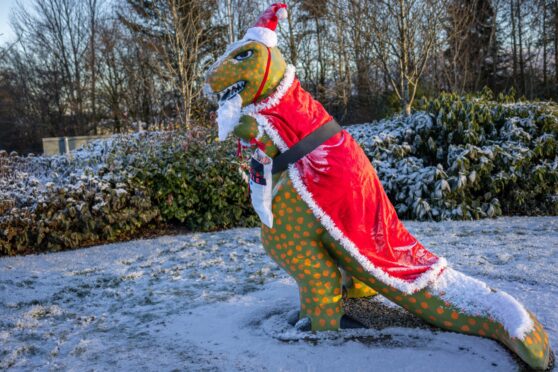 Rexie the Glenrothes dinosaur in his Santa suit