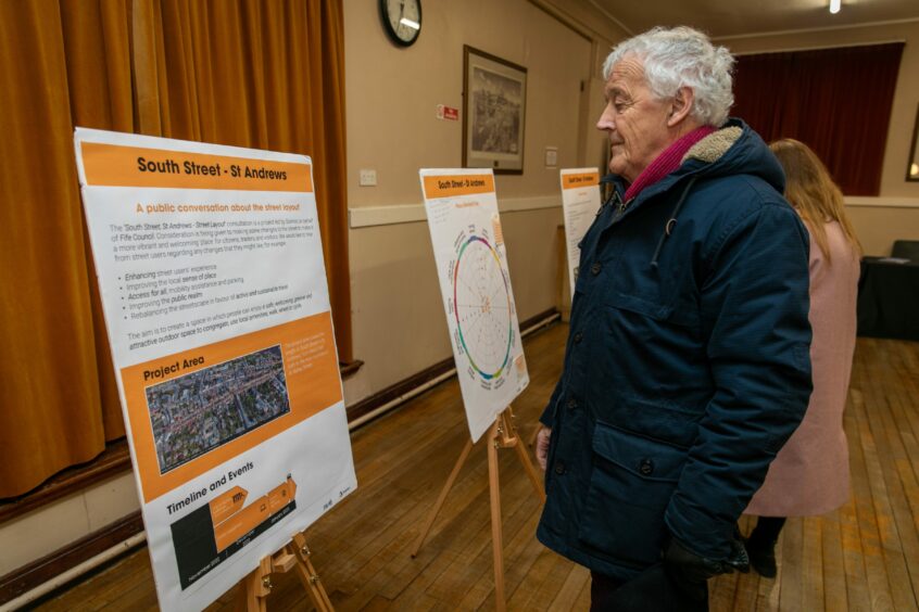 Bob Fraser (77) looks over the project plans for South Street in St Andrews. 