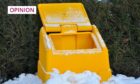 open grit bin surrounded by snow.