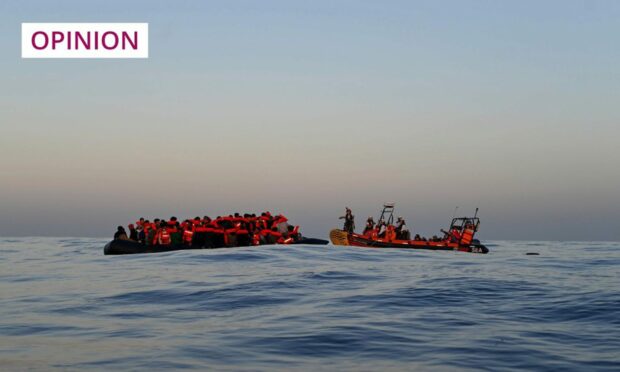 small boat carrying migrants in an empty ocean