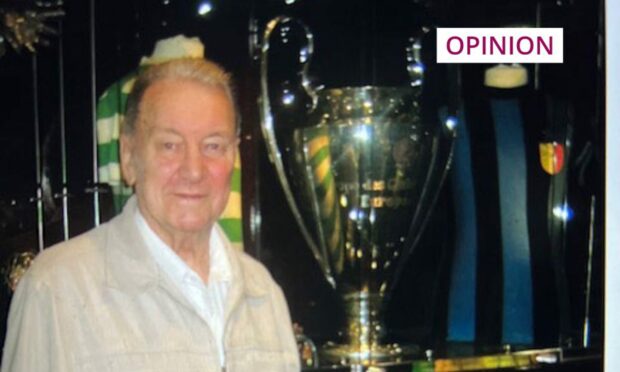 David Maxwell, in his 70s, next to a trophy cabinet at Celtic Park.