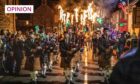 Comrie flambeaux parade led by bagpipers.